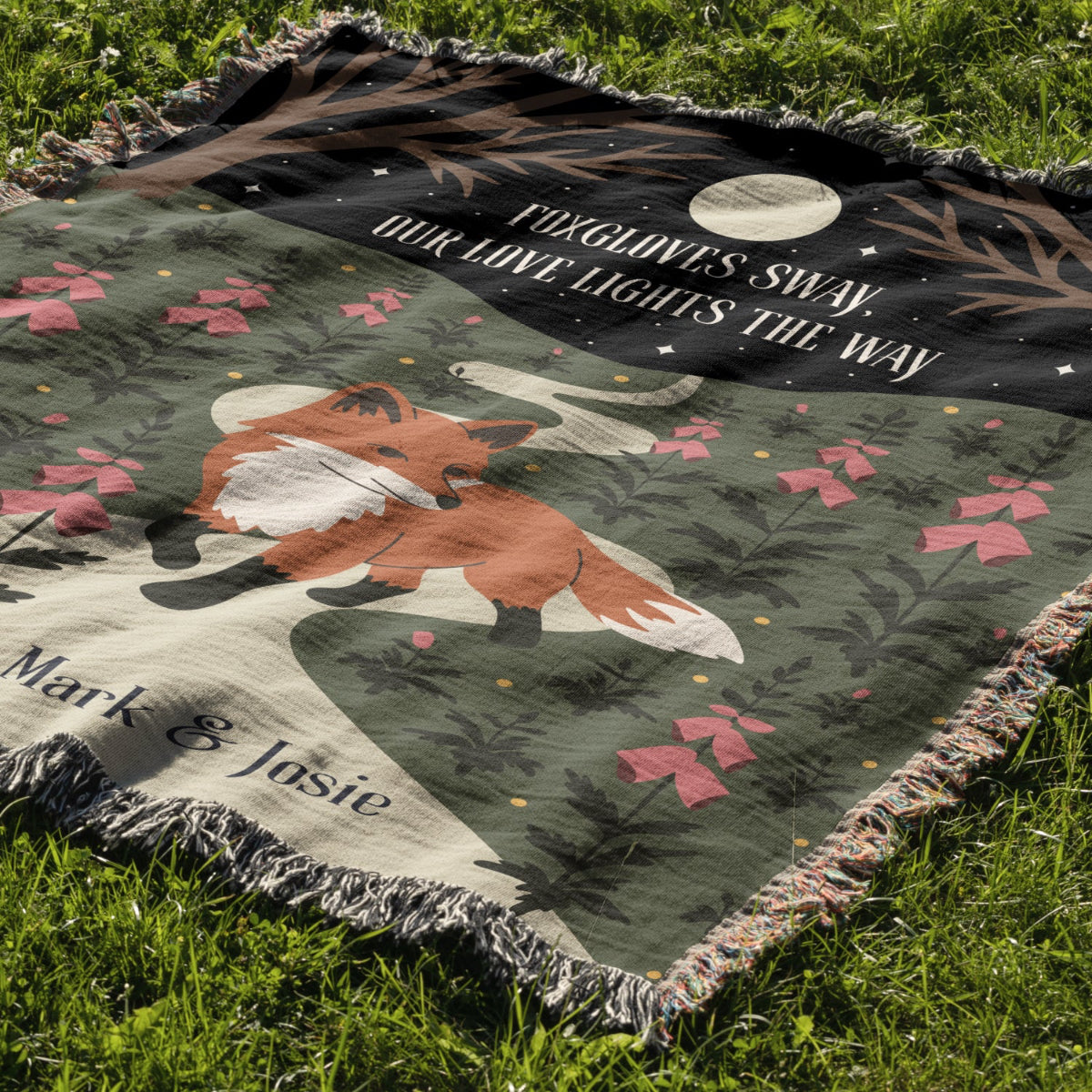 Blanket with fox design and text on grass