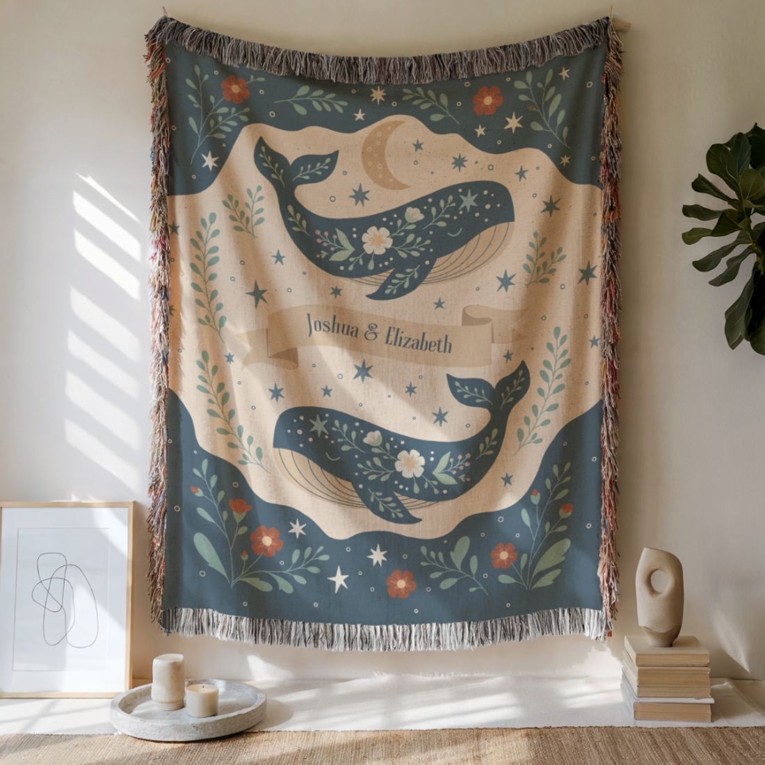 Decorative wall tapestry with whale design and personalized text in a room setting.