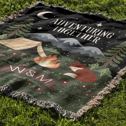 Blanket with foxes, camping scene, and 'Adventuring Together' text on grass